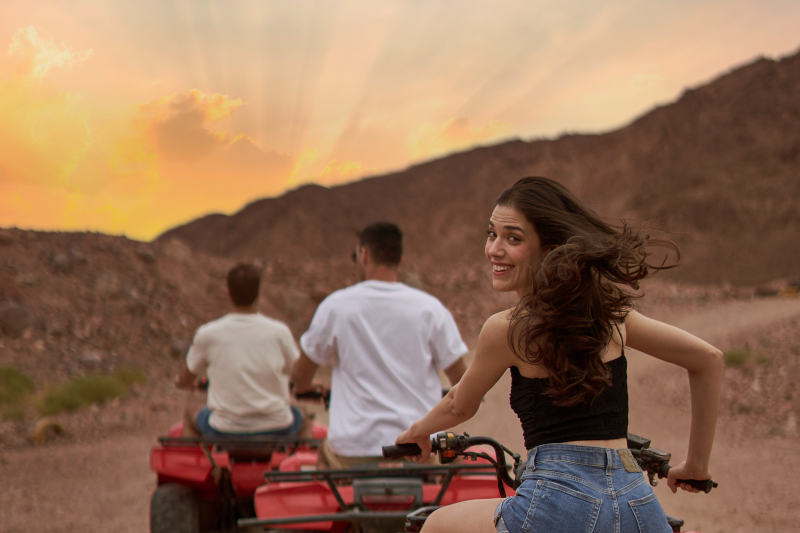 a girl and 2 boys on quadbikes in taba sinai