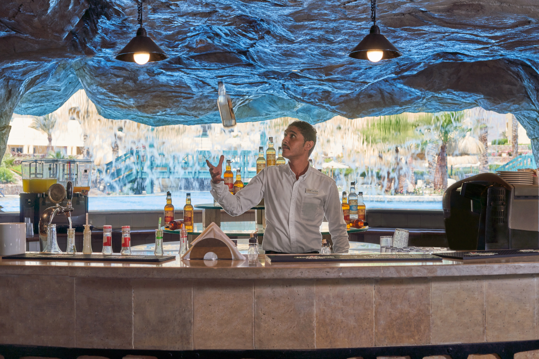 Bartender performing with bottles in the bar at Bayview Resort, Taba Heights